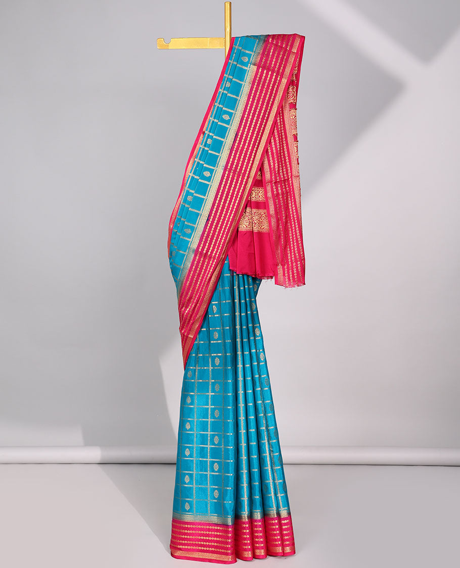 Blue floral motifs enclosed checked with contrast striped zari border & pallu of intricate design