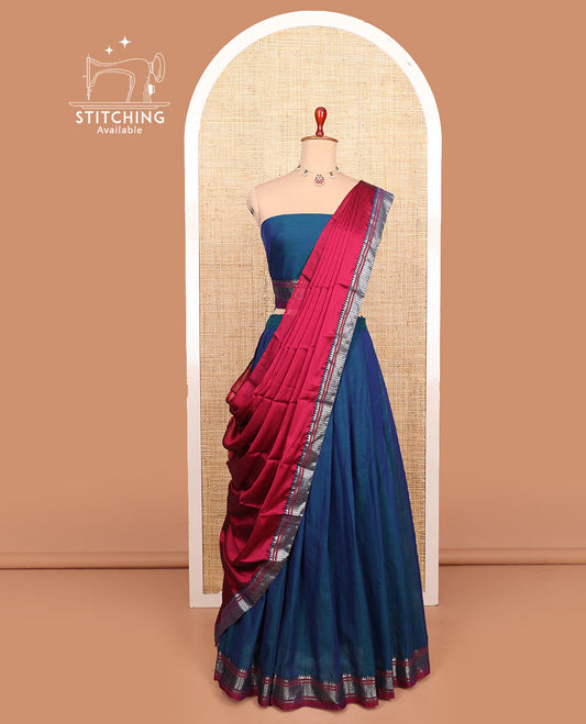 Blue plain cotton half-saree with traditional bordered skirt, matching blouse, and a contrast traditional bordered dhavani