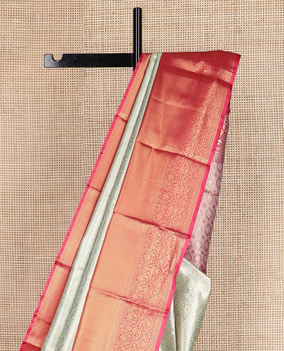 Light tea green floral jacquard budget silk saree, contrast traditional zari border, and ogee patterned pallu