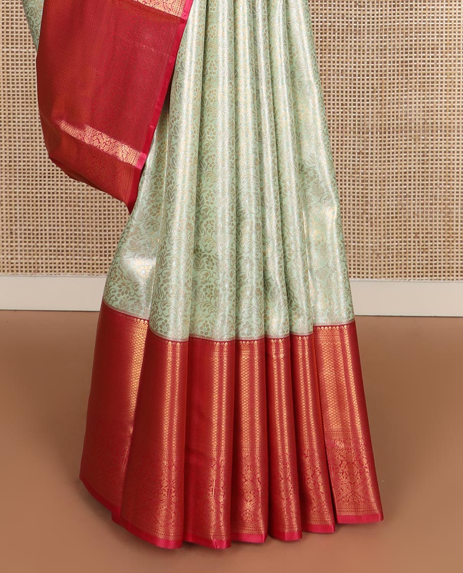 Light tea green floral jacquard budget silk saree, contrast traditional zari border, and ogee patterned pallu