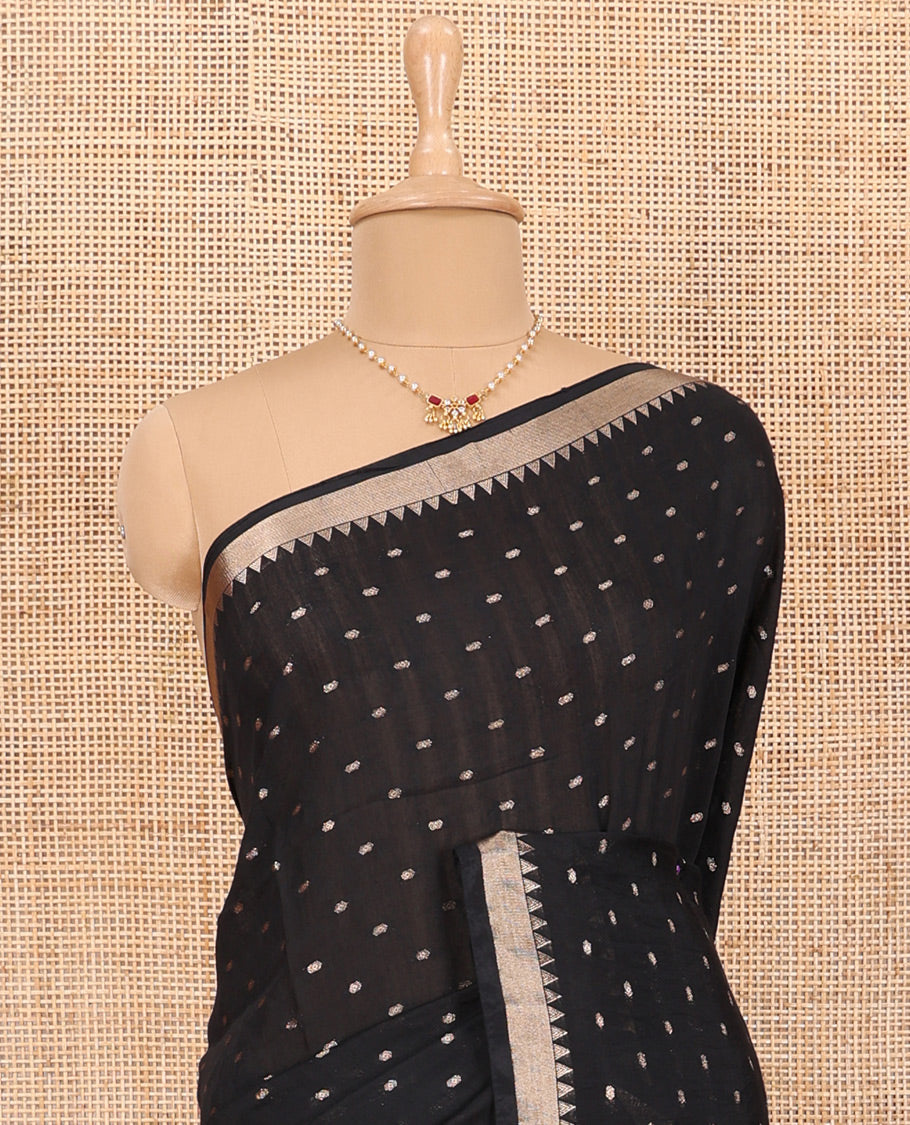 Black Assam Silk Saree Features Bright Zari Buttas All Over Its Body, a Subtle Temple Zari Border, a Pallu Highlighted with Zari Stripes, and Comes with a Matching Blouse