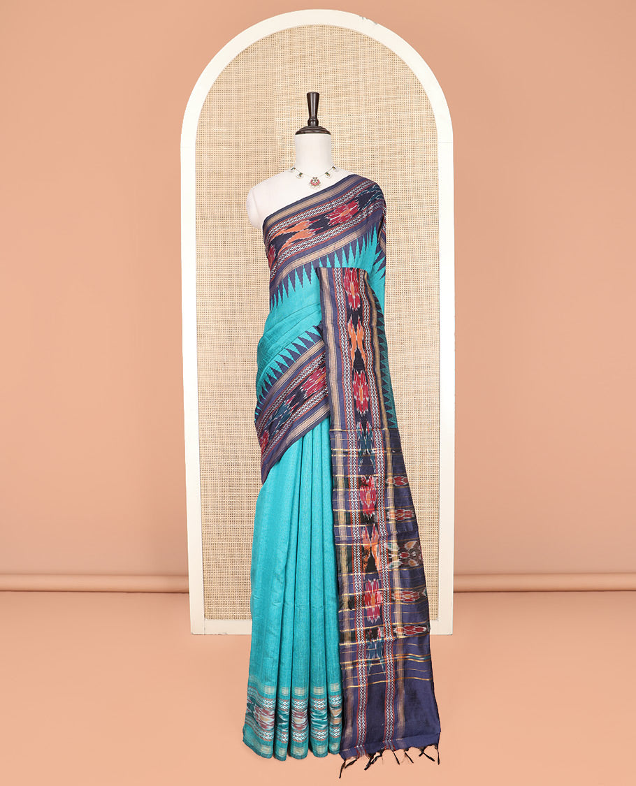 Light Blue Plain Dupion Silk Saree, Bedecked with a Contrast Temple Border of Geometric Patterns and Ikkat Weave, Pallu Depicting Floral Ikkat Designs, and Paired with a Contrast Blouse