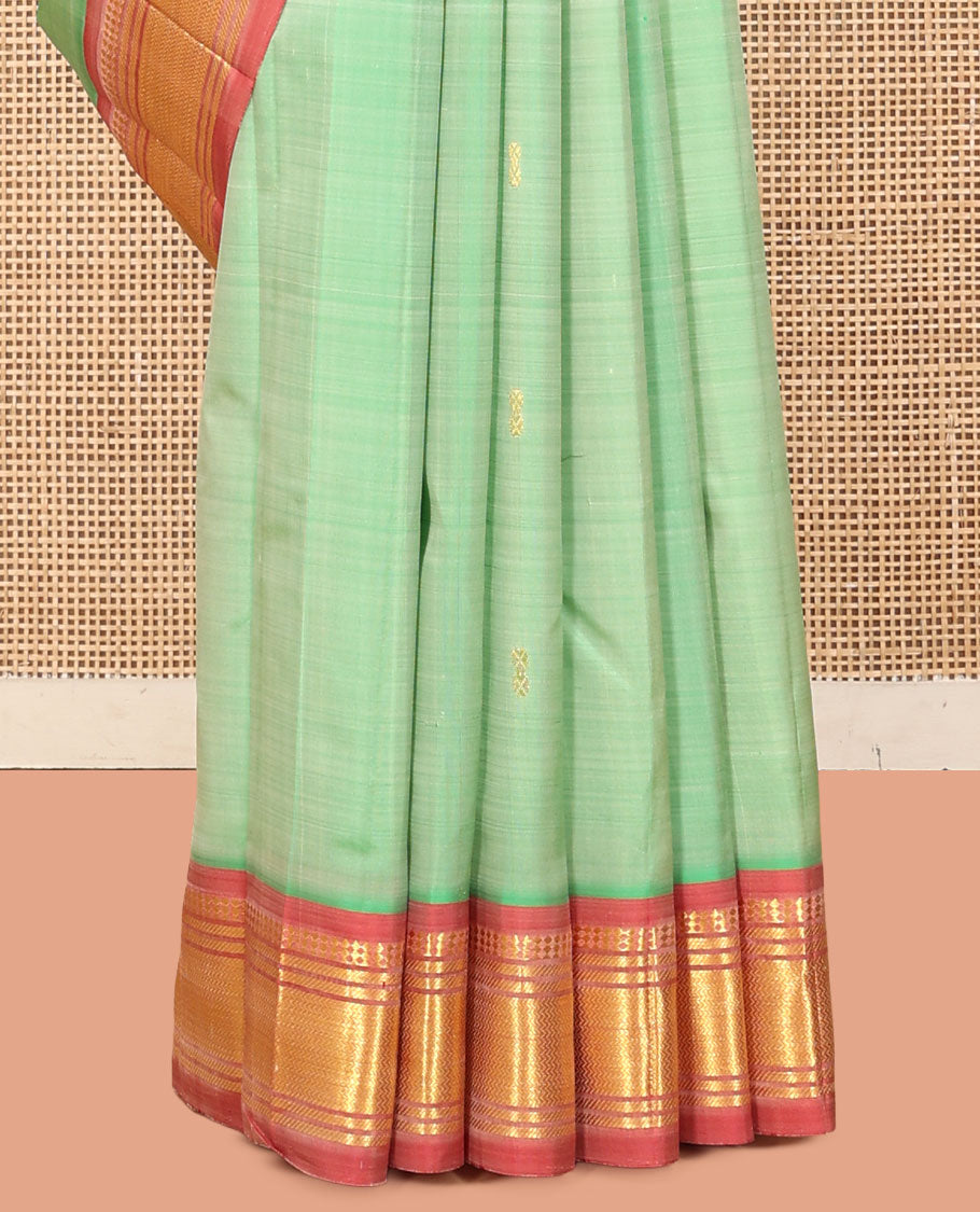 Green Kanchipuram Silk Saree, Showcasing Zari Buttas, a Contrast One-Sided Border of Panner Sombu, Banaras, and Vanki  Designs, a Zari Design Pallu, and No Blouse