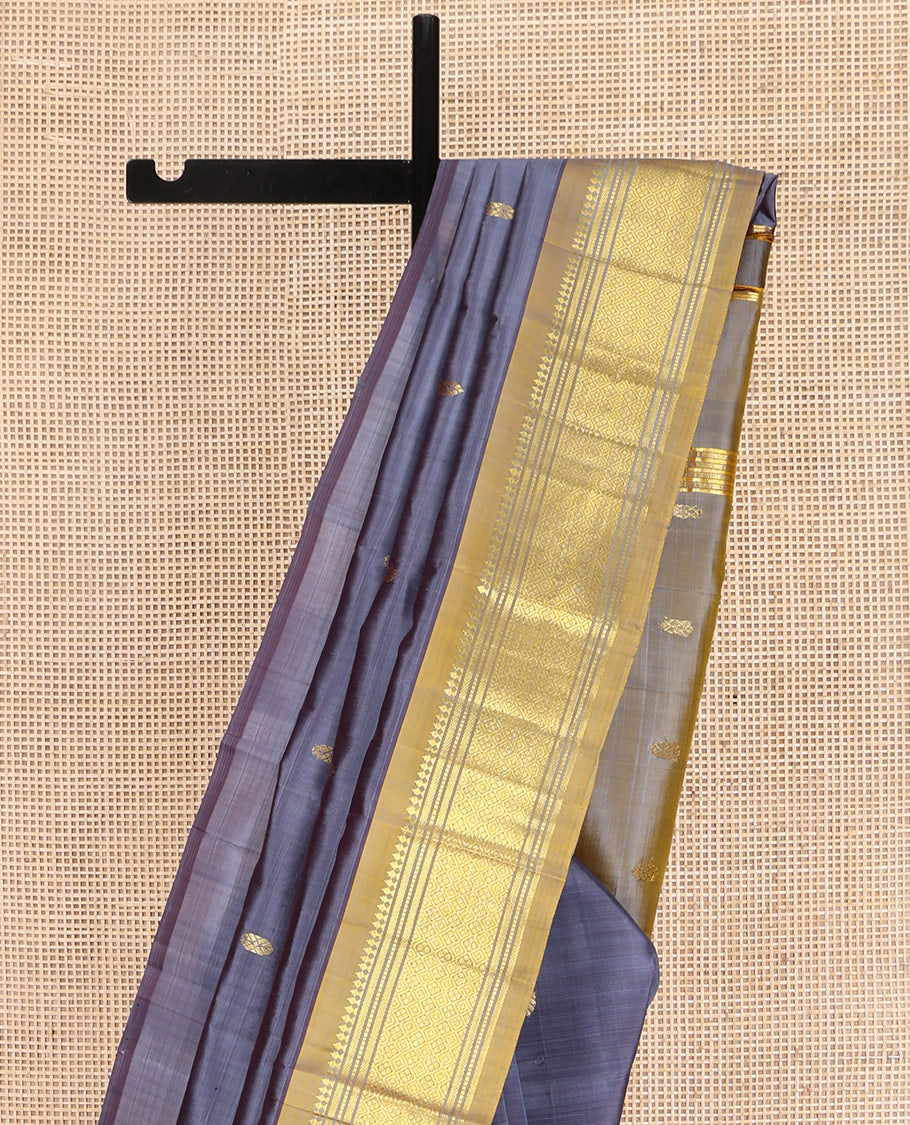 Grey Kanchipuram Silk Saree, Graced with Zari Buttas on Its Body, Complemented by a Contrast One-Sided Border of Panner Sombu, Banaras, Muthu, and Jaal Designs, Pallu of Zari Designs, and Comes Without a Blouse