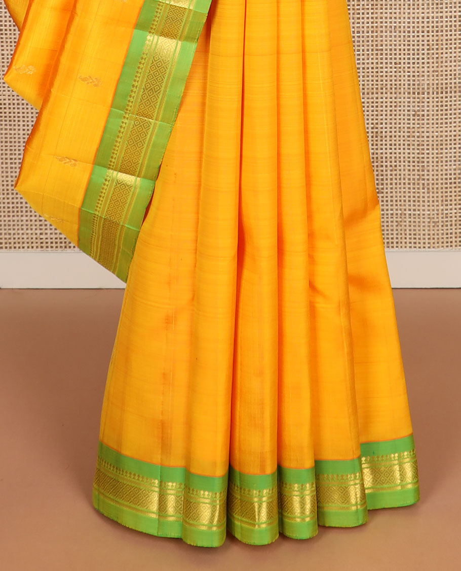 Yellow zari buttas kanchipuram silksaree, contrast one-sided border of paneer sombu,banaras & mayil kann design & zari design pallu