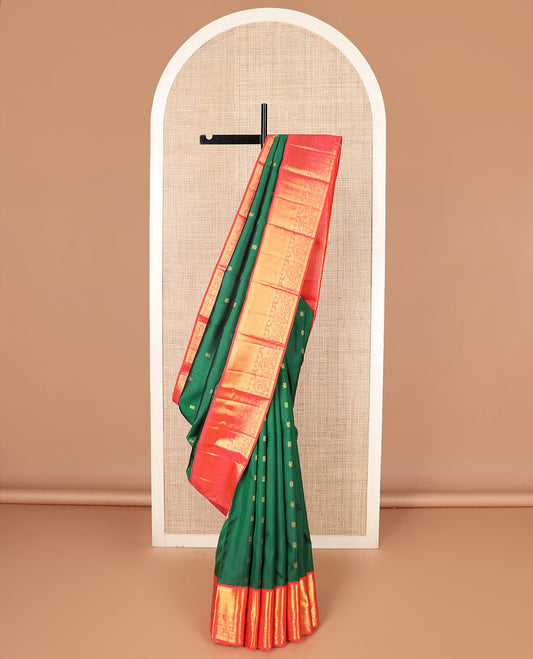 Green zari buttas Kanchipuram silk saree, contrast border of thilakam mokku, banaras, muthu, and mayil designs, and pallu of neli designs