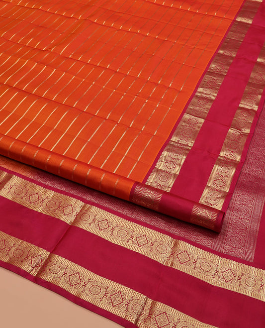 Orange Kanchipuram Silk Saree, Mesmerized with Zari Stripes on Its Body, Complemented by a Contrast Rettai Pettu Border of Manga, Muthu, Banaras, and Chakram Designs, Pallu of Intricate Design Weave, and Paired with a Contrast Blouse