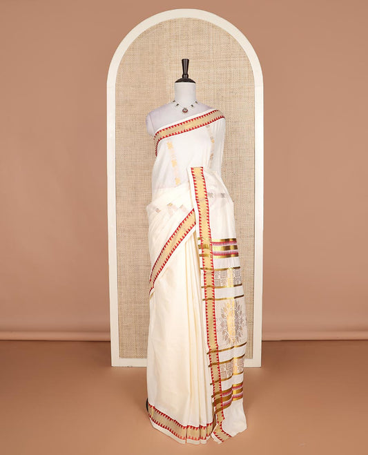 Cream zari design Kerala cotton saree, contrast temple border, and pallu of big chakram motifs