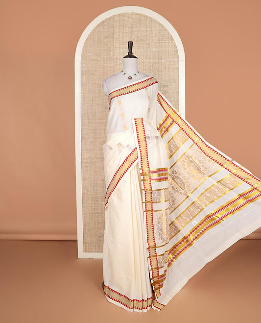 Cream zari design Kerala cotton saree, contrast temple border, and pallu of big chakram motifs