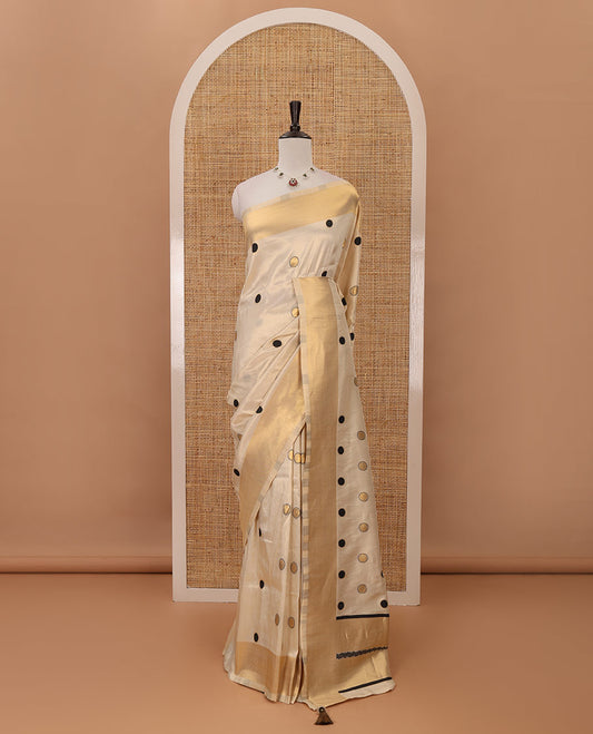Cream small black polka dots banarasi tissue saree, zari border, pallu of black polka dots & running plain blouse