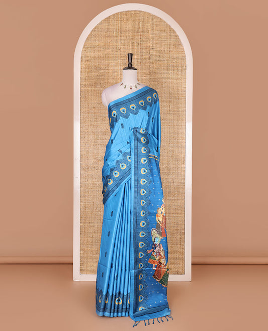 Blue peacock feathers motifs printed katan silk saree, peacock feathers printed border, contrast Radha Krishna stories printed pallu, and contrast printed blouse