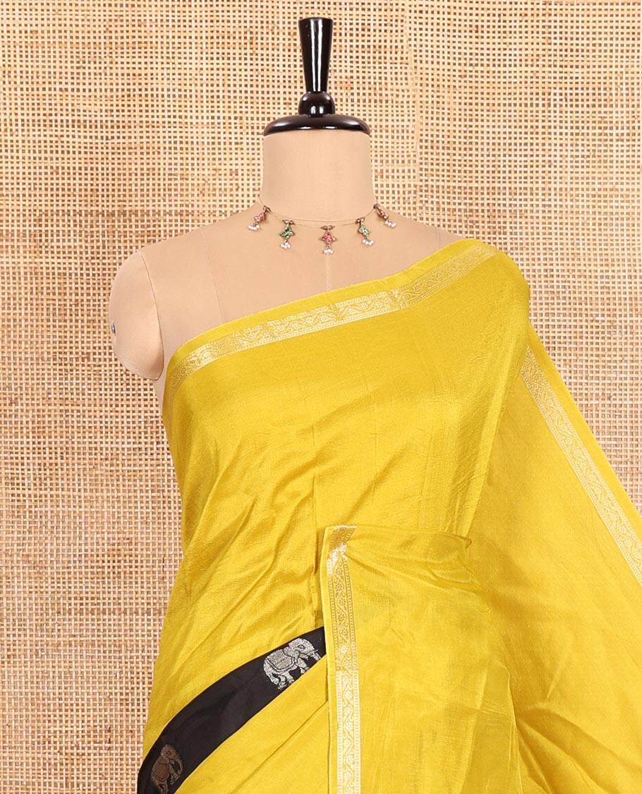 Yellow Russian Silk Saree Featuring Double-Sided Plain and Central Zari Elephant Motifs Weave, Accentuated by a Subtle Traditional Zari Border, Enhanced with a Zari-Designed Pallu, and Paired with a Blouse Depicting Meenakari Peacocks