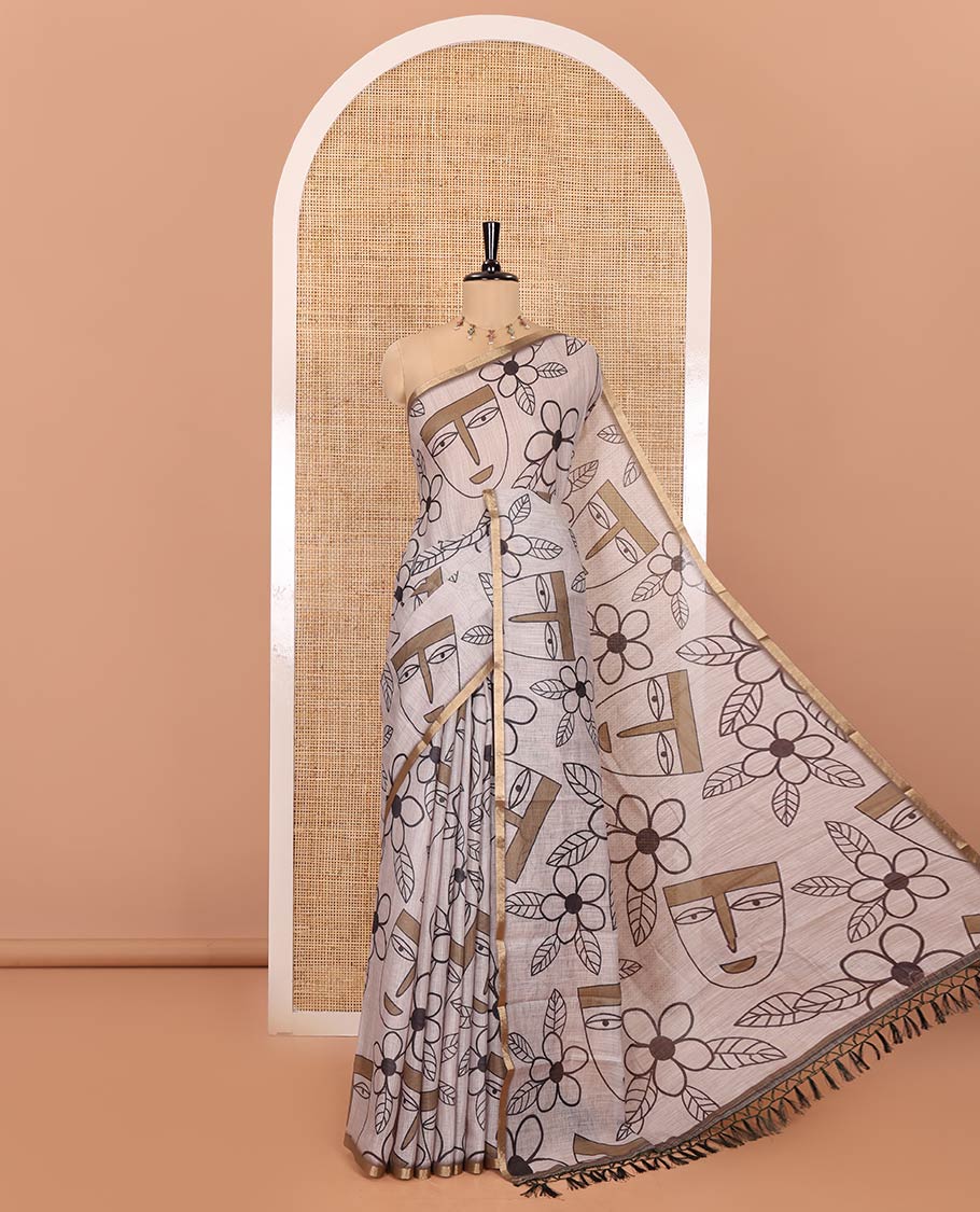 Green Linen Cotton Saree, Showcasing Flowers and Faces Printed on Its Body, Subtle Zari Piping Border, Pallu Mirrors the Self-Print, and Comes with a Contrast Blouse