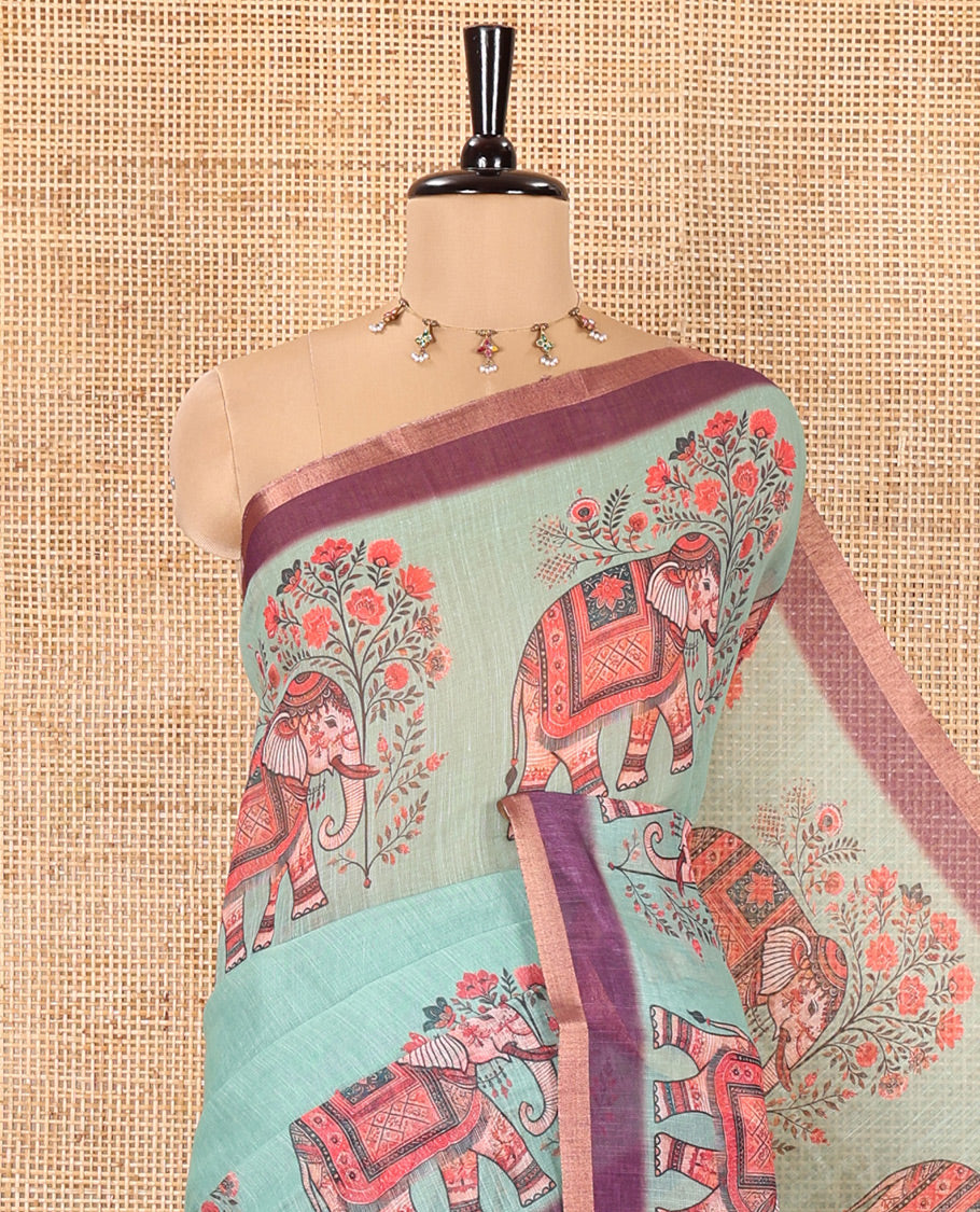 Green Plain Linen Cotton Saree, Artfully Detailed with Elephant Motifs on Piping Border, Pallu of Elephant Motifs Print, and Paired with a Contrast Blouse