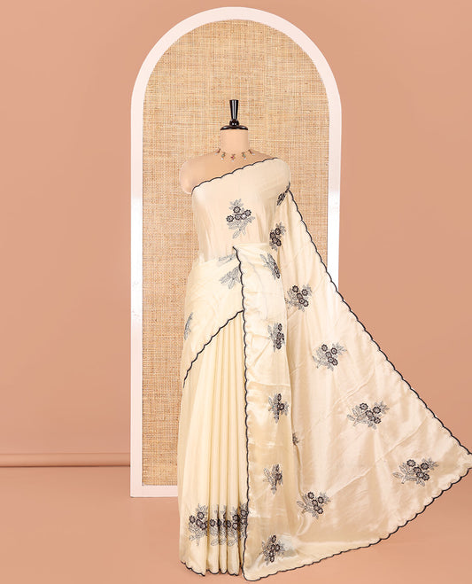 Chikku Rangoli Chiffon Saree, Delicately Woven with Flower-Style Motifs Embroidered on Its Body, a Subtle Scallop Embroidered Border, a Self-Pallu, and Paired with a Contrast Embroidered Blouse
