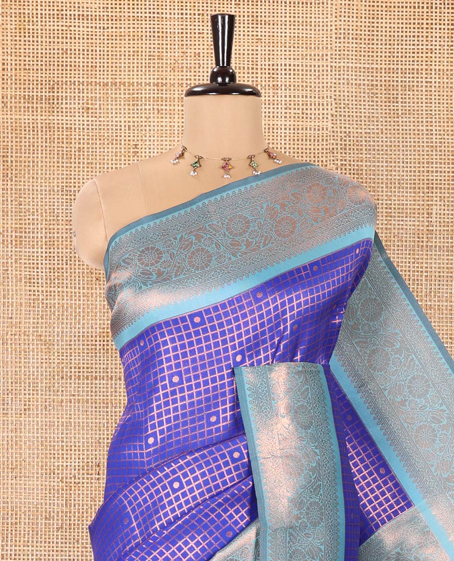 Blue Litchi Saree, Elegantly Framed with Polka Dot Buttas Enclosed Checks on Its Body, Complemented by a Contrast Traditional Zari Border of Floral Creeper Designs, Majestically Zari Detailed Pallu, and Paired with a Contrast Blouse