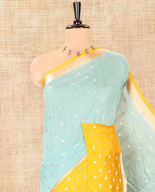 Green Assam Silk Saree, Subtly Enriched with Zari Buttas on Its Body, Complemented by Contrast Border Steeped with Zari Buttas, Pallu Steeped with Gleaming Zari Stripes and Buttas, and Paired with a Contrast Blouse