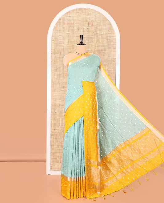Green Assam Silk Saree, Subtly Enriched with Zari Buttas on Its Body, Complemented by Contrast Border Steeped with Zari Buttas, Pallu Steeped with Gleaming Zari Stripes and Buttas, and Paired with a Contrast Blouse