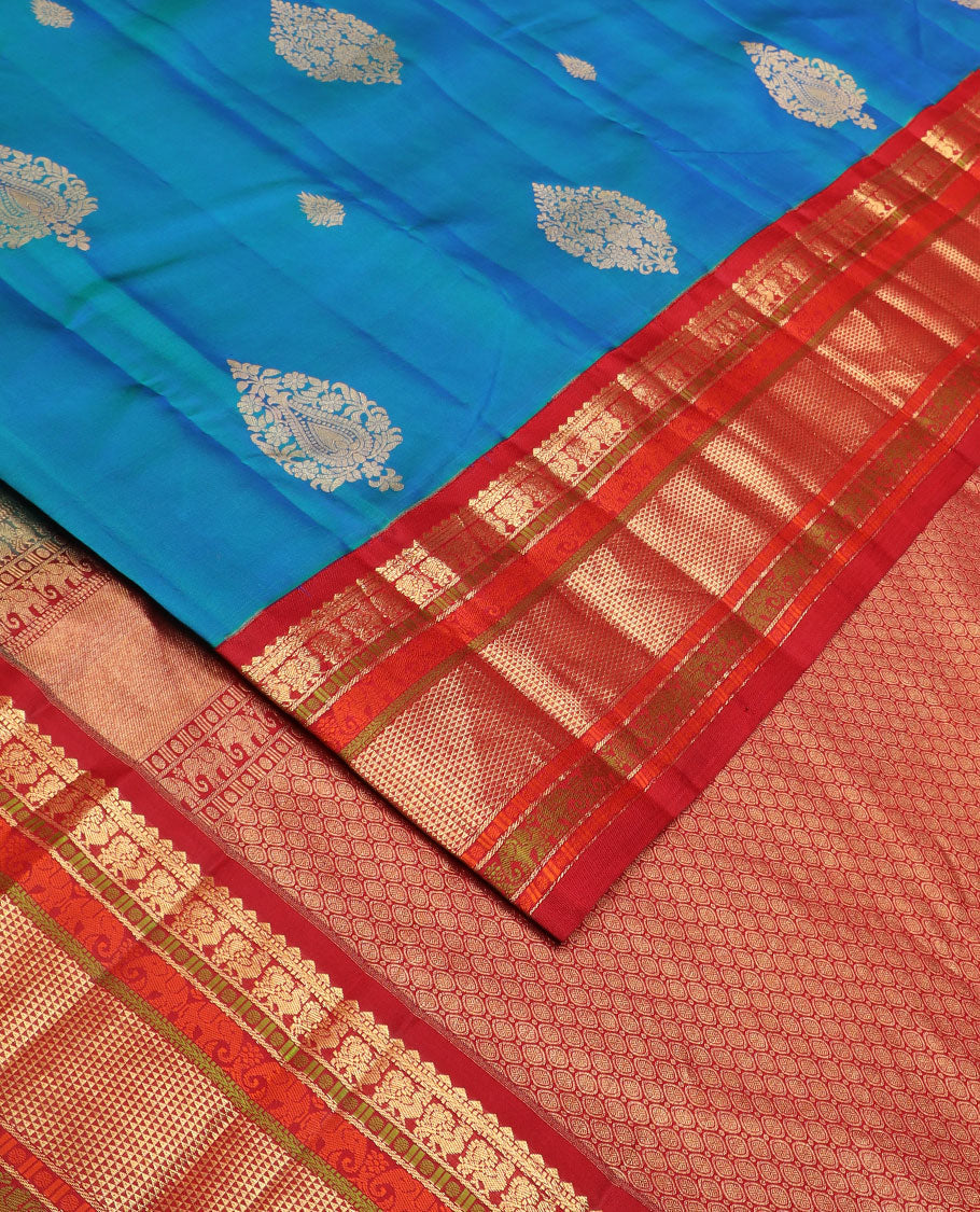 Blue zari buttas silk saree, contrast border of rekku,muthu,mayil,yaanai,rudraksham & ara maadam & circular motifs woven pallu