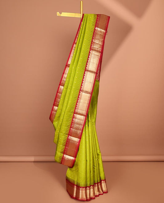 Green buttas silk saree, contrast border of rekku,banaras & jaal & pallu of ogee pattern