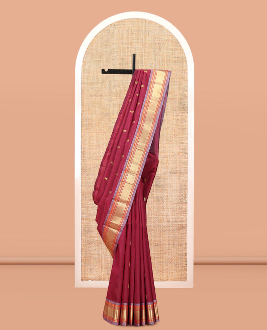 Maroon Kanchipuram Silk Saree, Ornamented with Zari Buttas, Complemented by a Contrast Border of Panner Sombu, Banaras, Muthu, and Vanki Design, Zari Design Pallu, and No Blouse