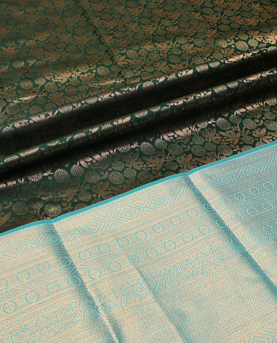 Green pure-silk half-saree, jacquard skirt, contrast blouse, and border of thilakam, banaras, poun, diamond, cross kamalam, and then kuli kann designs, and intricate dhavani