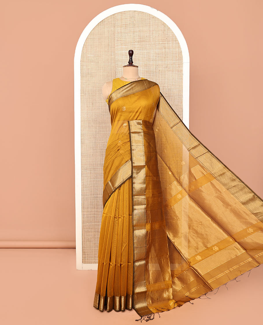 Mustard Maheshwari Cotton Saree, Beautified with Floral Buttas on Its Body, Highlighted by a Zari Border of Traditional Designs, Pallu Steeped with Gleaming Zari Stripes, and Paired with a Matching Blouse