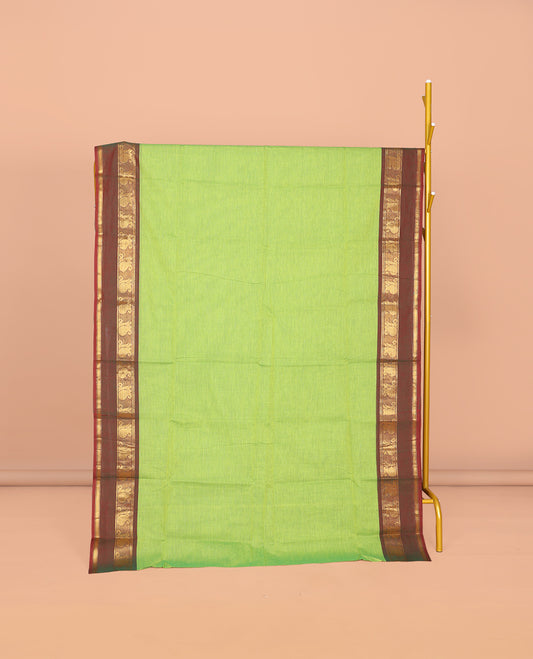 Parrot Green Plain Chettinad Cotton Saree, Complemented by Contrast Traditional Zari Design Rettai Pettu Border of Paisleys, Striped Pallu, and Paired with Matching Blouse