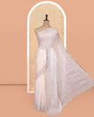 White Designer Saree, Enthralled with Stone Work All Over Its Body, a Scallop Stone Embroidered Border, and Matching Blouse