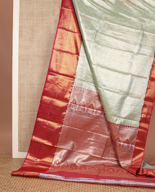 Light tea green floral jacquard budget silk saree, contrast traditional zari border, and ogee patterned pallu