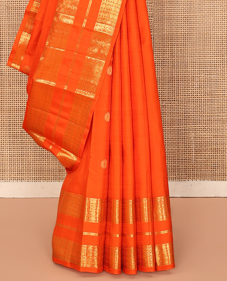 Orange Kanchipuram Silk Saree, Enthralled with Zari Buttas All Over Its Body, Highlighted by a Zari Varisai Border of Rudraksham Enclosed Muthu Kattam Designs, Pallu of Zari Designs, and Paired with a Matching Blouse