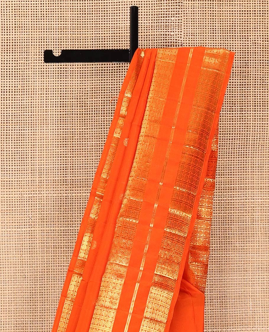 Orange Kanchipuram Silk Saree, Enthralled with Zari Buttas All Over Its Body, Highlighted by a Zari Varisai Border of Rudraksham Enclosed Muthu Kattam Designs, Pallu of Zari Designs, and Paired with a Matching Blouse