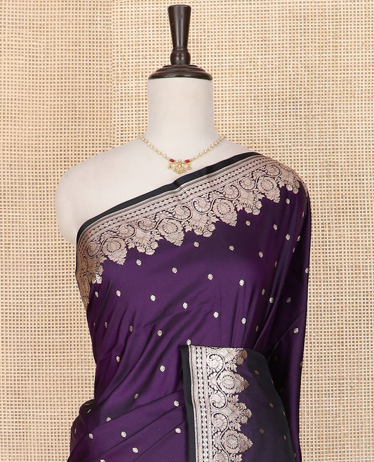 Violet Semi-Banaras Satin Saree Subtly Sparkled with Zari Buttas, Self-Border Gleamed Up with Intricate Designs, Pallu Artfully Detailed with Floral Jaal Designs, and Paired with a Matching Blouse