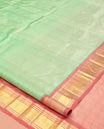 Green Kanchipuram Silk Saree, Showcasing Zari Buttas, a Contrast One-Sided Border of Panner Sombu, Banaras, and Vanki  Designs, a Zari Design Pallu, and No Blouse