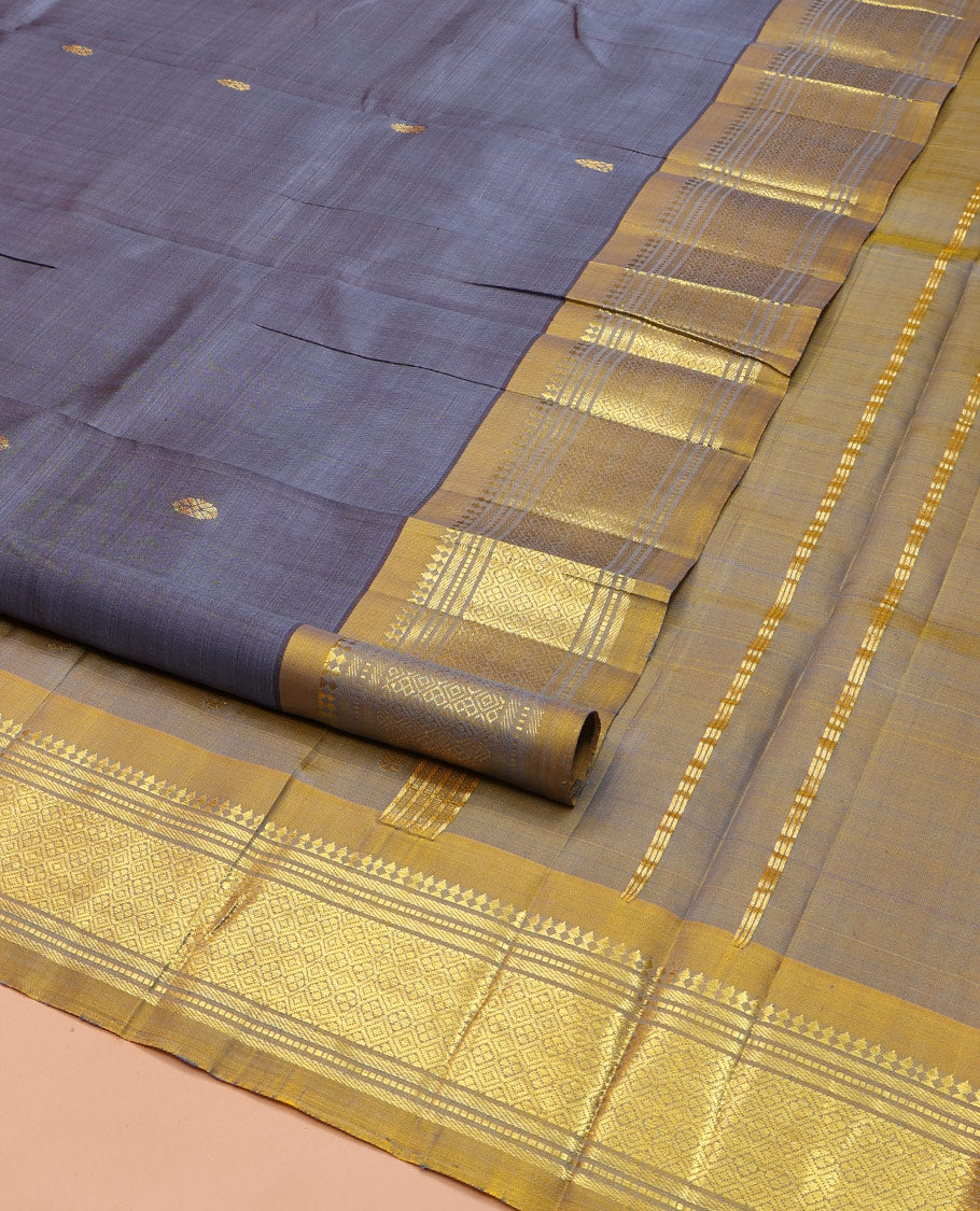 Grey Kanchipuram Silk Saree, Graced with Zari Buttas on Its Body, Complemented by a Contrast One-Sided Border of Panner Sombu, Banaras, Muthu, and Jaal Designs, Pallu of Zari Designs, and Comes Without a Blouse