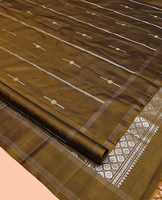 Green Mayuri Soft Silk Saree, Graced with Zari Buttas All Over Its Body, Highlighted by Zari Striped Border, Pallu Steeped with Zari Buttas, and Paired with a Matching Blouse
