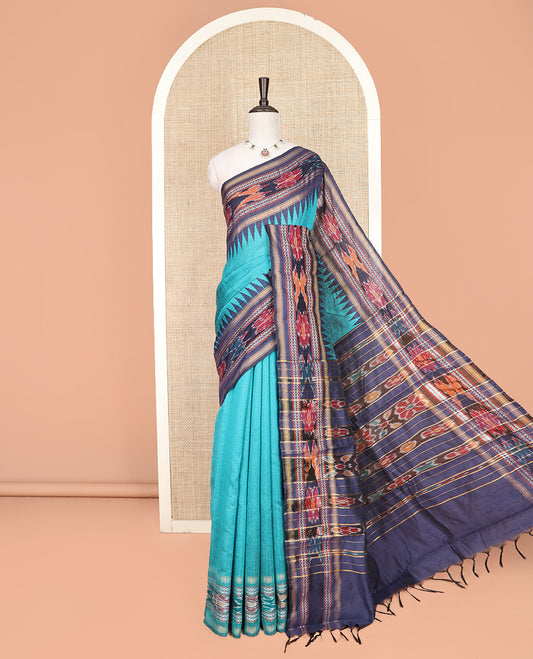 Light Blue Plain Dupion Silk Saree, Bedecked with a Contrast Temple Border of Geometric Patterns and Ikkat Weave, Pallu Depicting Floral Ikkat Designs, and Paired with a Contrast Blouse