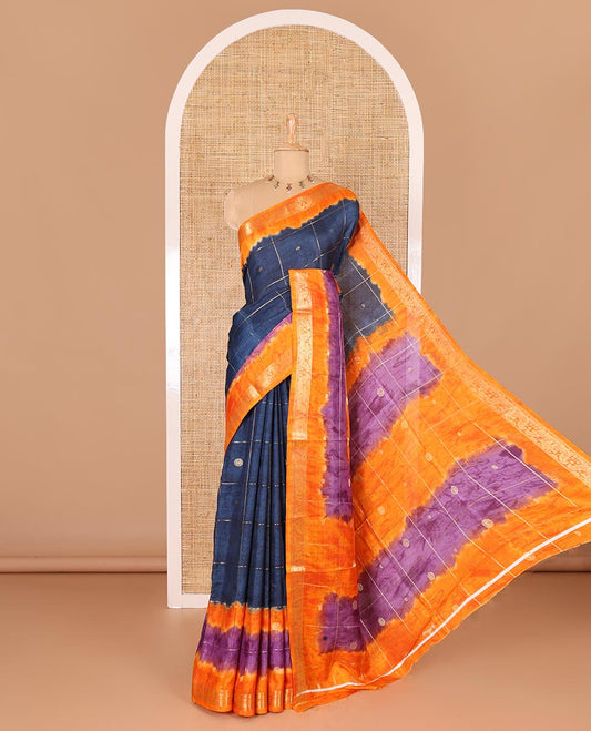 Blue buttas enclosed checked dola silk saree, contrast shibori print with traditional zari border, buttas enclosed checked pallu, and a contrast buttas enclosed checked blouse