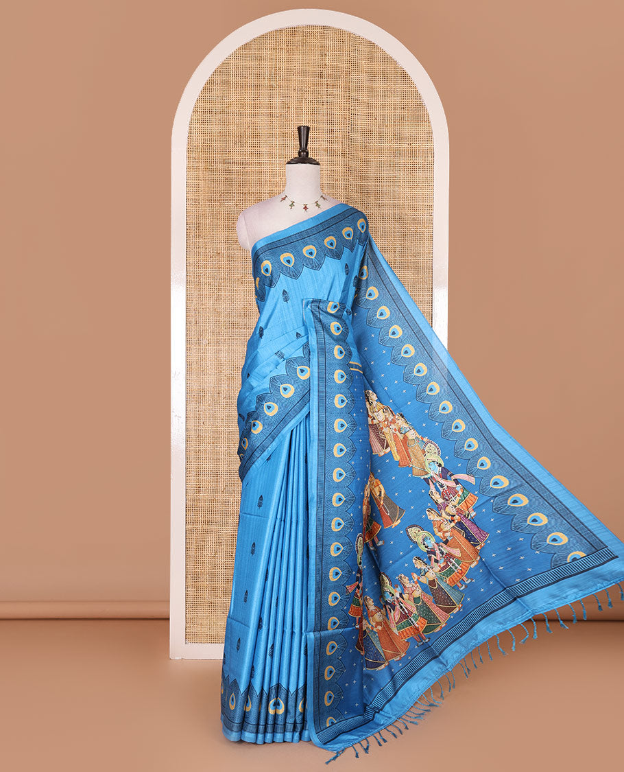 Blue peacock feathers motifs printed katan silk saree, peacock feathers printed border, contrast Radha Krishna stories printed pallu, and contrast printed blouse