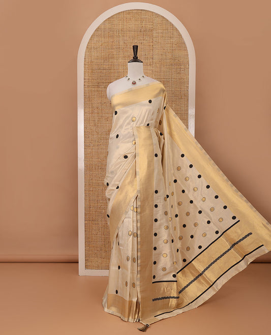 Cream small black polka dots banarasi tissue saree, zari border, pallu of black polka dots & running plain blouse