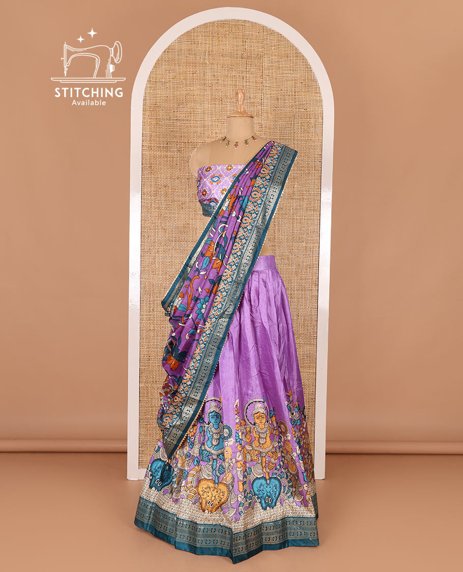 Purple semi-tussar half-saree, kalamkari human figurines printed with a contrast geometric bordered skirt, patola printed blouse, and kalamkari floral vine printed dhavani
