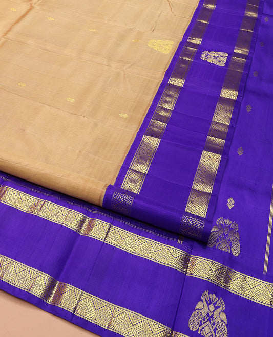 Sandal Kanchipuram Silk Saree, Highlighted with Zari Buttas on Its Body, Complemented by a Contrast One-Sided Korvai Border of Diamond and Mayil Designs, Pallu Features Floral and Paisley Designs, and Comes Without a Blouse