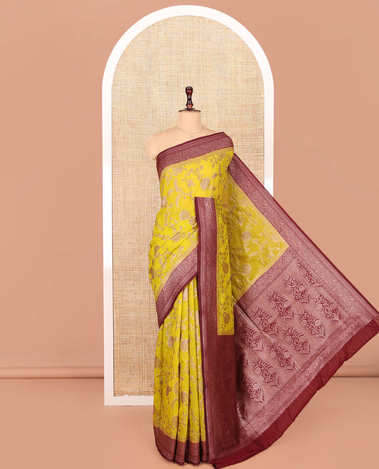 Yellow Georgette Saree, Artfully Detailed with Floral Jaal Jacquard Design on Its Body, Complemented by a Contrast Paisley Design Zari Woven Border, Pallu Depicts Mughal-Style Floral Zari Designs, and Paired with a Contrast Blouse