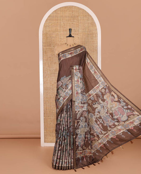 Brown kalamkari human figurines printed fancy tussar saree, floral printed border, human figurines printed pallu, and a matching blouse