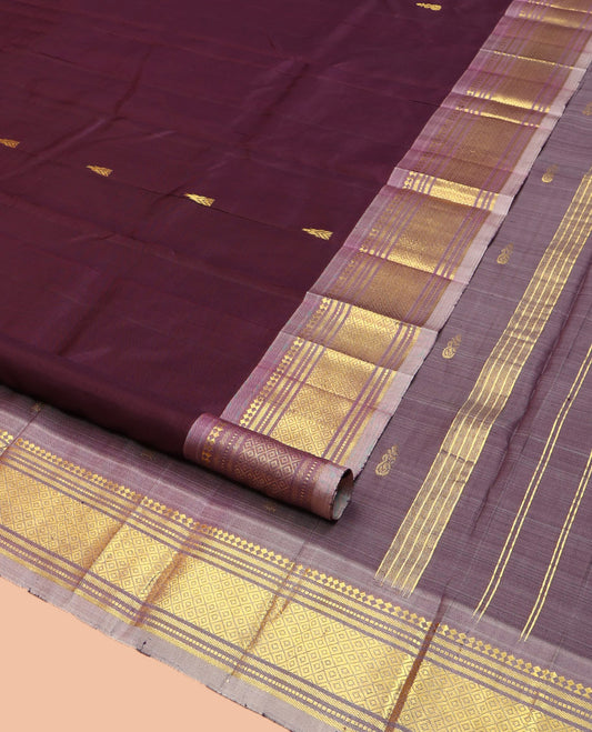Brown Kanchipuram Silk Saree, Ornamented with Thazampoo Rekku Zari Buttas on Its Body, Complemented by Contrast One-Sided Border of Panner Sombu, Banaras, Muthu, and Mayil Kann Designs, Pallu Features Zari Designs, and Comes Without a Blouse