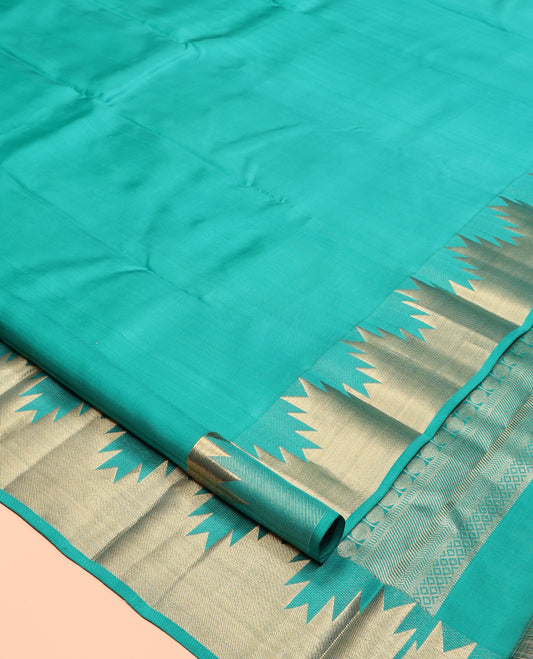 Green Plain Kanchipuram Silk Saree, Highlighted by a Zari Thazampoo Rekku Border, Geometric Patterned Pallu, and Matching Blouse