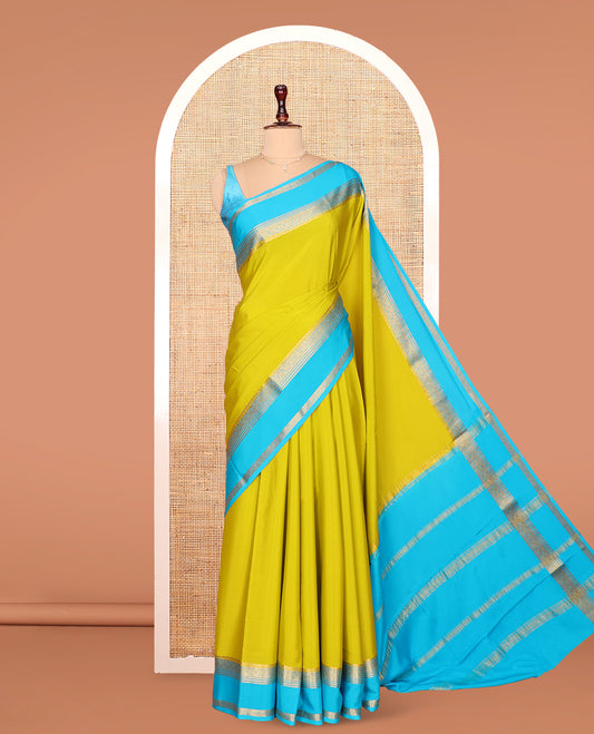 Green Plain Mysore Silk Saree, Complemented by Captivating Contrast Border of Traditional Zari Designs, Subtly Striped Pallu, and Paired with a Contrast Blouse