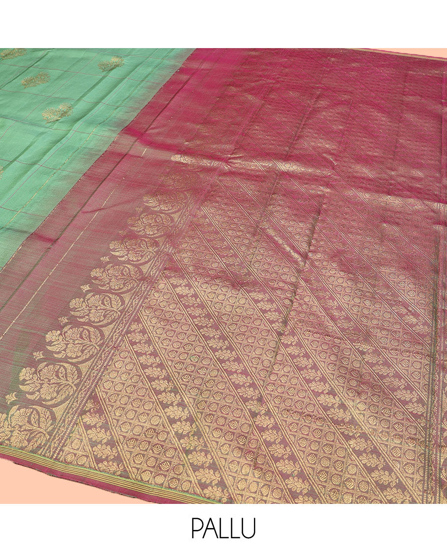 Green Kanchipuram Silk Saree, Beautifully Woven with Floral Butta Enclosed, Checked All Over Its Body, Subtle Zari Piping Border, Captivating Pallu of Intricate Designs, and Paired with a Contrast Blouse