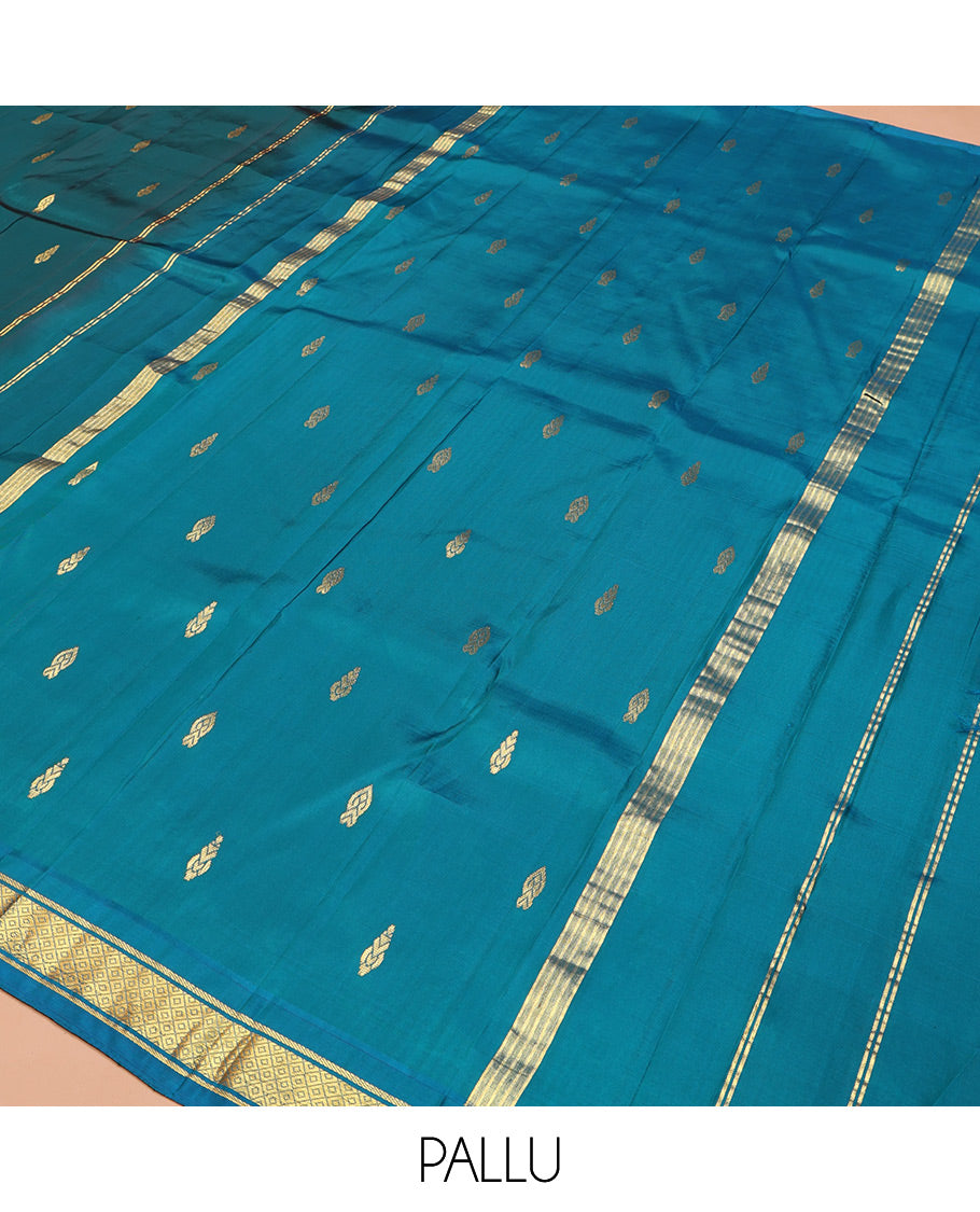 Blue Kanchipuram Silk Saree, Adorned with Zari Buttas on Its Body, Complemented by a Contrast One-Sided Border of Banaras, and Mayil Kann Designs, Pallu Steeped with Zari Designs, and Comes Without a Blouse