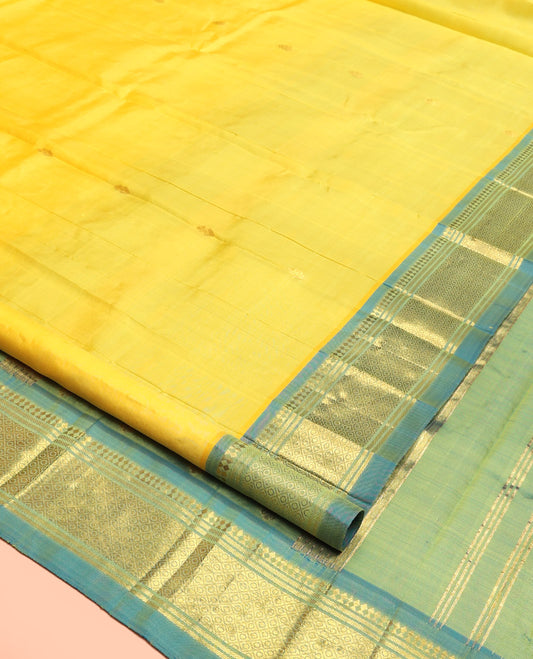 Yellow Kanchipuram Silk Saree, Subtly Sparkled with Zari Buttas, Contrast One-Sided Border of Paneer Sombu, Banaras, and Mayil Kann, Zari Design Pallu, and No Blouse